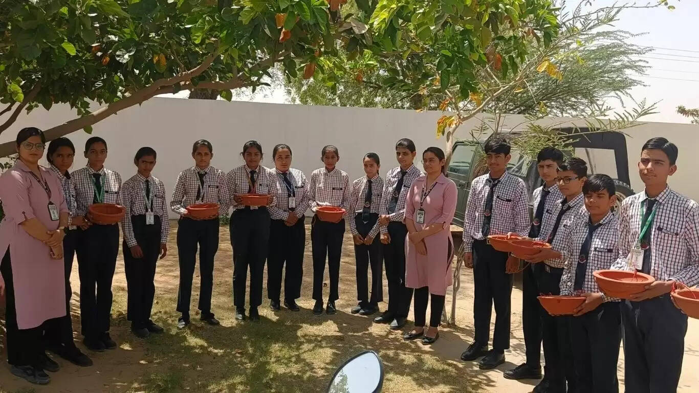 On Earth Day, students of Rigveda Public School of village Shakkarmandori installed water pots to quench the thirst of birds